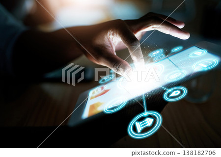 Person, hand and tablet at night with hologram, UI or 3D HUD and dashboard with icons on desk at office. Closeup of employee working late on technology in digital marketing or networking at workplace Person, hand and tablet at night with hologram, UI or 3D HUD and dashboard with icons on desk at office. Closeup of employee working late on technology in digital marketing or networking at workplace 138182706