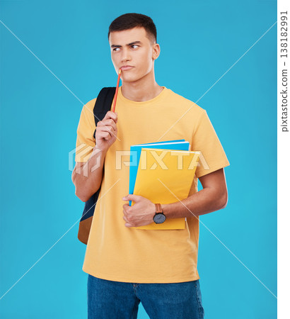 Man, student thinking and choice for college, university or scholarship with books, research and funding solution in studio. Person with decision, confused or ideas for education on a blue background 138182991