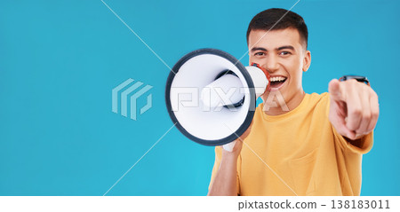Megaphone, smile and portrait of man in studio pointing for announcement, speech or rally. Happy, protest and young person from Canada with bullhorn for loud communication isolated by blue background Megaphone, smile and portrait of man in studio pointing for announcement, speech or rally. Happy, protest and young person from Canada with bullhorn for loud communication isolated by blue background 138183011