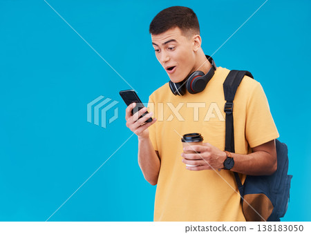 Student, winner and man wow for phone news, college results or scholarship success on a blue background. Young person reading notification, winning and social media on mobile with surprise in studio Student, winner and man wow for phone news, college results or scholarship success on a blue background. Young person reading notification, winning and social media on mobile with surprise in studio 138183050