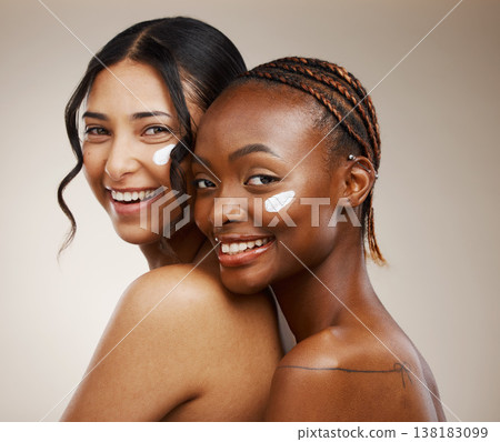 Women, cream on face and beauty with diversity, friends and inclusive skincare on studio background. Dermatology, natural cosmetics and happiness in portrait, wellness and skin glow with moisturizer Women, cream on face and beauty with diversity, friends and inclusive skincare on studio background. Dermatology, natural cosmetics and happiness in portrait, wellness and skin glow with moisturizer 138183099