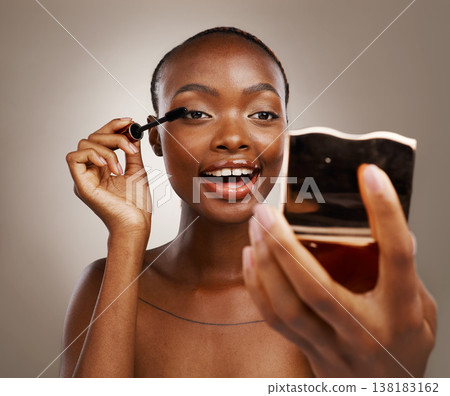 Black woman, mascara with brush and mirror, makeup and shine with beauty isolated on brown background. Eyelash extension, wand and skin glow with cosmetology, transformation and wellness in studio Black woman, mascara with brush and mirror, makeup and shine with beauty isolated on brown background. Eyelash extension, wand and skin glow with cosmetology, transformation and wellness in studio 138183162