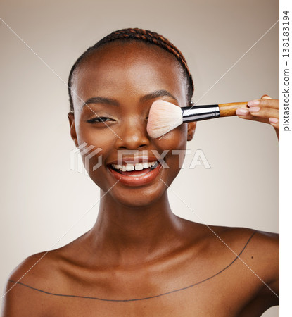 Black woman, portrait and brush for makeup on eye with beauty and smile for dermatology on studio background. Glow, foundation or powder with cosmetic tools, wellness and cosmetology with skincare 138183194