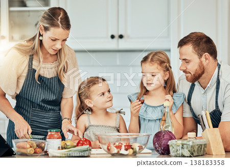 Happy family in kitchen, cooking together with children and teaching, learning and nutrition with parents. Mom, dad and girl kids help making healthy food in home with care, support and love at lunch Happy family in kitchen, cooking together with children and teaching, learning and nutrition with parents. Mom, dad and girl kids help making healthy food in home with care, support and love at lunch 138183358