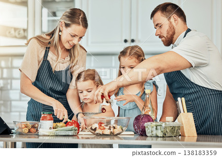 Happy family in kitchen, cooking together with kids and teaching, learning and nutrition with parents. Mom, dad and girl children help making healthy food in home with care, support and love at lunch Happy family in kitchen, cooking together with kids and teaching, learning and nutrition with parents. Mom, dad and girl children help making healthy food in home with care, support and love at lunch 138183359
