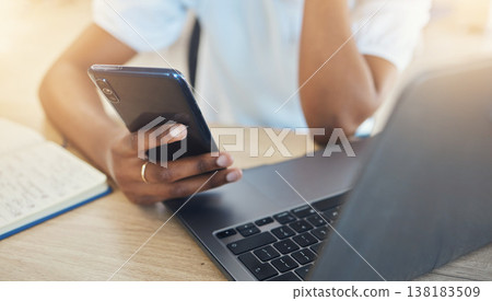 Woman, hand and phone with laptop for communication, social media or schedule of business in closeup. Female, analyst and technology at desk for contact, email and internet for search in office 138183509