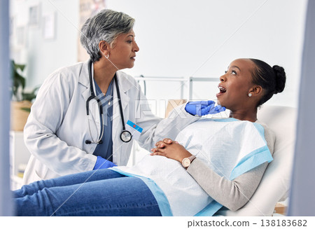 Dentist, patient and women at clinic, consultation and check mouth for dental health and medical treatment. Oral hygiene, healthcare and surgery, orthodontics and tooth decay with cleaning for cavity Dentist, patient and women at clinic, consultation and check mouth for dental health and medical treatment. Oral hygiene, healthcare and surgery, orthodontics and tooth decay with cleaning for cavity 138183682