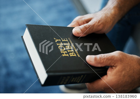 Bible, book and hands of man in home with study of Christian faith, religion or spirituality knowledge. Holy, worship and person with gospel, scripture or learning about God or story of Jesus Christ Bible, book and hands of man in home with study of Christian faith, religion or spirituality knowledge. Holy, worship and person with gospel, scripture or learning about God or story of Jesus Christ 138183960