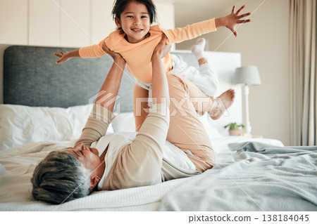 Woman, girl child and bed for airplane game, portrait and smile with lift, flying and bonding in family home. Senior lady, kid and plane with flight, love and care with freedom, balance and fantasy 138184045