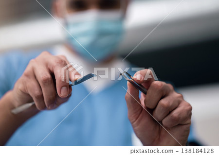 Healthcare, surgery and hands of doctor with tools, emergency care or professional career in hospital. Medicine, expert surgeon in operating room or theater with steel equipment for medical procedure Healthcare, surgery and hands of doctor with tools, emergency care or professional career in hospital. Medicine, expert surgeon in operating room or theater with steel equipment for medical procedure 138184128