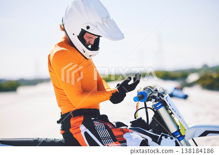 Motorbike, safety gear and ready for race in desert, training and practice for challenge on sand dunes. Athlete, outdoor and adrenaline in extreme sports, fitness and competition on dirt bike Motorbike, safety gear and ready for race in desert, training and practice for challenge on sand dunes. Athlete, outdoor and adrenaline in extreme sports, fitness and competition on dirt bike 138184186