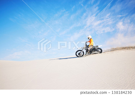 Motorbike, travel and person with competition, sand and blue sky with sports, training and transport. Biker, desert and athlete with practice, fitness and safety with exercise, freedom and adventure Motorbike, travel and person with competition, sand and blue sky with sports, training and transport. Biker, desert and athlete with practice, fitness and safety with exercise, freedom and adventure 138184230