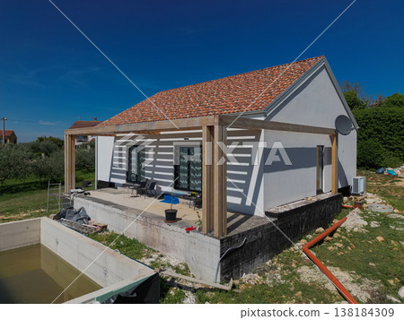Modular modern smart automated house under construction with finished and unfinished sections, aerial view of work in progress Modular modern smart automated house under construction with finished and unfinished sections, aerial view of work in progress 138184309
