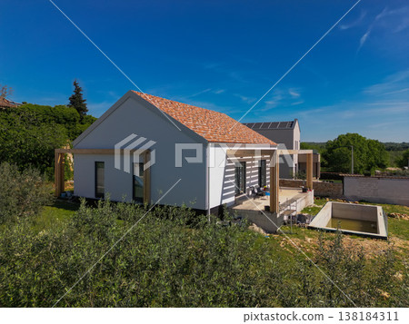 Aerial view of a modular modern smart house with automated features and ongoing construction work Aerial view of a modular modern smart house with automated features and ongoing construction work 138184311