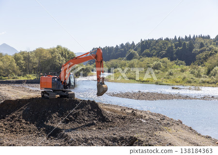 Heavy machinery used to widen the river channel 138184363
