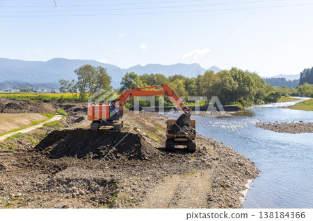 Heavy machinery used to widen the river channel Heavy machinery used to widen the river channel 138184366