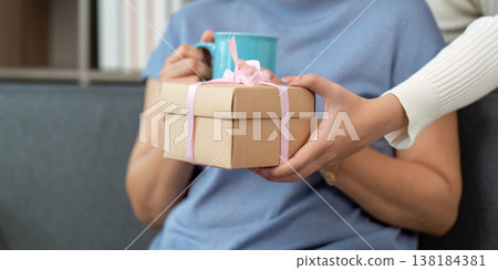 Gift exchange between mother and daughter Gift exchange between mother and daughter 138184381
