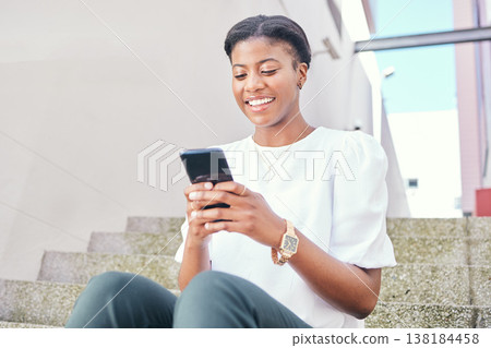 Phone, stairs and young woman in a building networking on social media, mobile app or the internet. Smile, technology and African female person scroll on website with cellphone in a modern office. 138184458