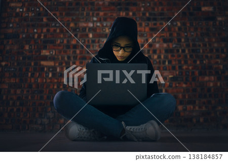 Hacker, woman in basement with laptop and information technology, phishing and cyber crime with database or server. Cybersecurity, programming and criminal with pc, ransomware and firewall breach Hacker, woman in basement with laptop and information technology, phishing and cyber crime with database or server. Cybersecurity, programming and criminal with pc, ransomware and firewall breach 138184857