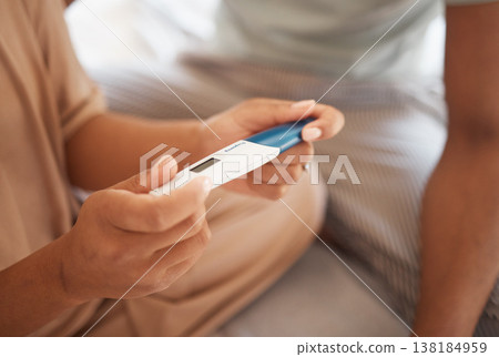 Pregnancy test, closeup and hands of couple in their house with results, news or expectation. Pregnant, love and zoom on man with woman checking home testing kit for family planning or ivf success 138184959