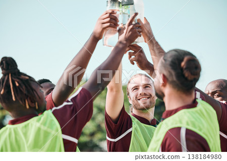 Soccer team, water bottle and toast with teamwork, achievement and support on field. Fitness, workout and sport training of men group with smile and celebration at game outdoor with drink and cheers Soccer team, water bottle and toast with teamwork, achievement and support on field. Fitness, workout and sport training of men group with smile and celebration at game outdoor with drink and cheers 138184980
