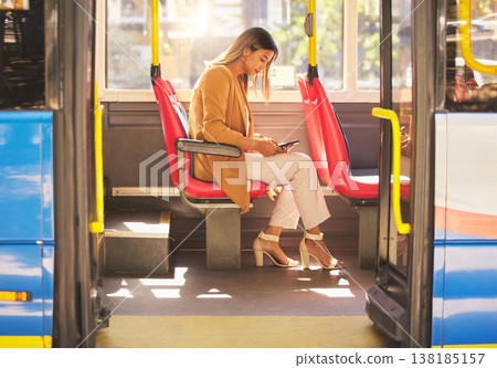 Woman in bus, sitting and typing on smartphone for social media, email and and travel on urban commute. Public transport, service and drive, girl with phone reading schedule or agenda on road to work Woman in bus, sitting and typing on smartphone for social media, email and and travel on urban commute. Public transport, service and drive, girl with phone reading schedule or agenda on road to work 138185157