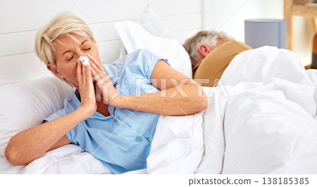 Blowing nose, couple or sick old woman in bed with husband with flu virus, cold or health problem. Sneeze, mature or senior person with tissue toilet paper, fever or allergy illness in home bedroom Blowing nose, couple or sick old woman in bed with husband with flu virus, cold or health problem. Sneeze, mature or senior person with tissue toilet paper, fever or allergy illness in home bedroom 138185385