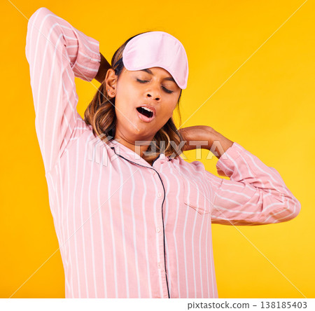 Woman, pajamas and yawn with stretch in studio for sleep or peaceful for stress, tired or sad for burnout. Female model, eye mask and relax for dream or wake up for insomnia, headache or self care Woman, pajamas and yawn with stretch in studio for sleep or peaceful for stress, tired or sad for burnout. Female model, eye mask and relax for dream or wake up for insomnia, headache or self care 138185403