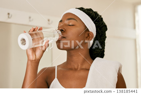 Tennis, health and woman drinking water, fitness and tired with workout, fatigue or exercise. African person, athlete or player with bottle with liquid, aqua or wellness with training or sports Tennis, health and woman drinking water, fitness and tired with workout, fatigue or exercise. African person, athlete or player with bottle with liquid, aqua or wellness with training or sports 138185441
