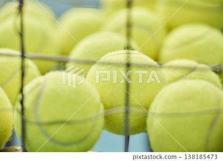 Tennis ball, close up and basket for training or sport for exercise, cardio or serve for game. Sports equipment, tournament and turf for professional athlete or health for outdoor workout or fitness Tennis ball, close up and basket for training or sport for exercise, cardio or serve for game. Sports equipment, tournament and turf for professional athlete or health for outdoor workout or fitness 138185473