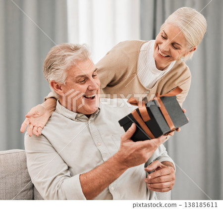 Happy couple, together and surprise with gift at house for retirement, birthday or anniversary on vacation. Elderly, man and woman in celebration of event with happiness, love and care for partner Happy couple, together and surprise with gift at house for retirement, birthday or anniversary on vacation. Elderly, man and woman in celebration of event with happiness, love and care for partner 138185611