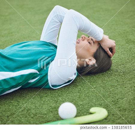 Hockey player, woman is tired in field with fitness and sport, challenge or loss with burnout outdoor. Exercise, wellness and fatigue with fail in competition, mistake and crisis on stadium turf Hockey player, woman is tired in field with fitness and sport, challenge or loss with burnout outdoor. Exercise, wellness and fatigue with fail in competition, mistake and crisis on stadium turf 138185655