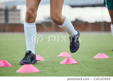 Cone, legs or athlete running in training, workout and warm up exercise on a outdoor hockey field or turf. Closeup, healthy or sports person on grass playing in a practice game for fitness speed 138185660