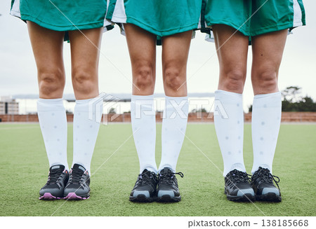 Legs, feet and a woman hockey team outdoor on a field for a game or competition together in summer. Fitness, exercise or sports with people on a pitch of a grass for training or teamwork on match day Legs, feet and a woman hockey team outdoor on a field for a game or competition together in summer. Fitness, exercise or sports with people on a pitch of a grass for training or teamwork on match day 138185668