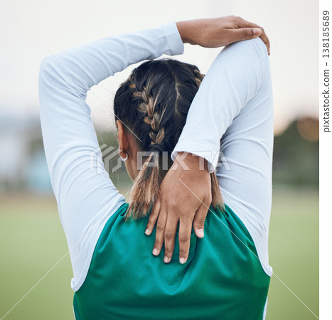 Back, stretching and a woman hockey player getting ready for the start of a game or competition outdoor. Sports, fitness and warm up with an athlete on a field for a training workout or practice Back, stretching and a woman hockey player getting ready for the start of a game or competition outdoor. Sports, fitness and warm up with an athlete on a field for a training workout or practice 138185689