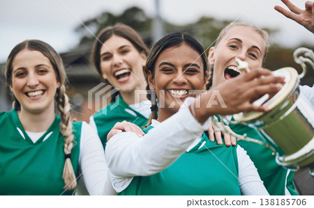 Sports women, team and winning trophy in portrait, celebration and success in competition on field. Champion girl group, friends and diversity for hockey, goal or happy outdoor at stadium for contest Sports women, team and winning trophy in portrait, celebration and success in competition on field. Champion girl group, friends and diversity for hockey, goal or happy outdoor at stadium for contest 138185706