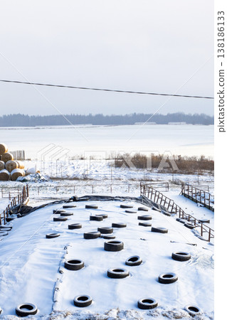 Frozen harbor scene evokes abandonment. Desolate rooftop overlooks icy harbor with debris Frozen harbor scene evokes abandonment. Desolate rooftop overlooks icy harbor with debris 138186133