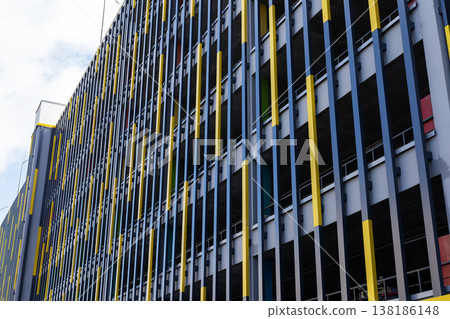 Building facade showcases bright yellow lines creating shadow patterns and rhythm Building facade showcases bright yellow lines creating shadow patterns and rhythm 138186148