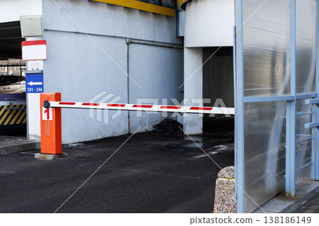 Automated security barrier blocking vehicle entry on industrial concrete surface with signage 138186149