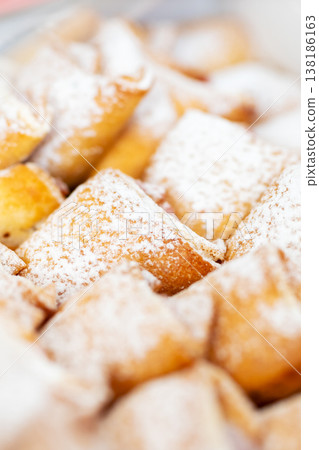 Sweet breakfast treat. Closeup of powdered sugar dessert with soft filling and crispy edges Sweet breakfast treat. Closeup of powdered sugar dessert with soft filling and crispy edges 138186163