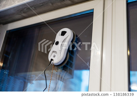 Mechanical cleaning system independently maintains and sanitizes glass panels during evening hours 138186339