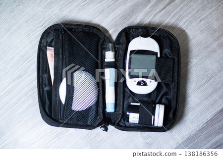 Personal blood sugar measurement kit arranged on gray fabric background for home use Personal blood sugar measurement kit arranged on gray fabric background for home use 138186356