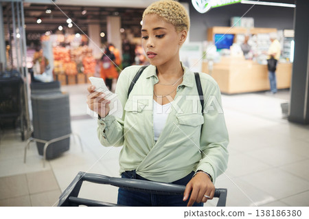 Woman, grocery shopping and receipt for budget, inflation or price check in supermarket of sale or discount. African customer with cost of living, retail and food choice or paper at convenience store 138186380
