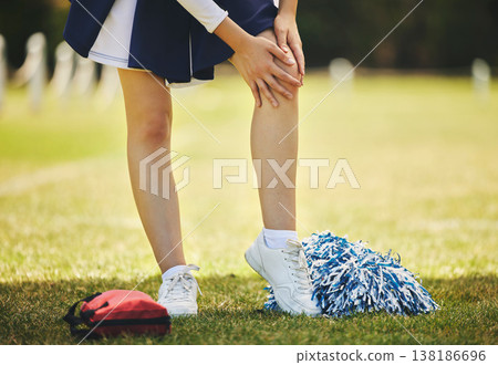 Cheerleader, injury and person with knee pain from sport, training and cheer exercise on a grass field. Health, accident and leg muscle bruise outdoor with emergency or workout challenge for wellness Cheerleader, injury and person with knee pain from sport, training and cheer exercise on a grass field. Health, accident and leg muscle bruise outdoor with emergency or workout challenge for wellness 138186696