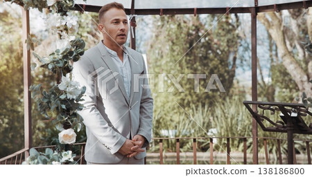Waiting, groom and man in wedding and ceremony at alter with anxiety, stress or nervous energy for marriage or commitment. Formal, suit and excited person standing in aisle with flowers and nature Waiting, groom and man in wedding and ceremony at alter with anxiety, stress or nervous energy for marriage or commitment. Formal, suit and excited person standing in aisle with flowers and nature 138186800