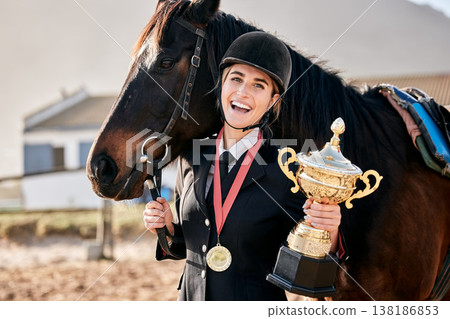 Portrait, equestrian and prize horse with a woman on a ranch for sports, training or a leisure hobby. Winner, trophy or award and a happy young rider in uniform with her stallion or mare outdoor Portrait, equestrian and prize horse with a woman on a ranch for sports, training or a leisure hobby. Winner, trophy or award and a happy young rider in uniform with her stallion or mare outdoor 138186853
