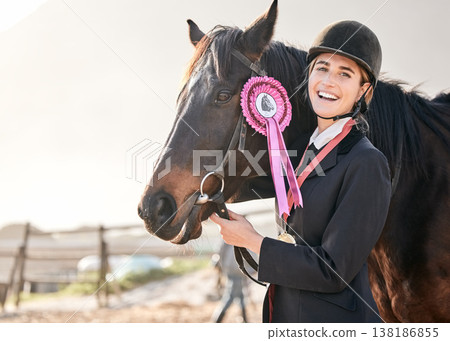 Portrait, horse riding and a woman winner with an animal on a ranch for sports, training or a leisure hobby. Equestrian, award or prize ribbon and a happy young rider in uniform with her mare outdoor Portrait, horse riding and a woman winner with an animal on a ranch for sports, training or a leisure hobby. Equestrian, award or prize ribbon and a happy young rider in uniform with her mare outdoor 138186855