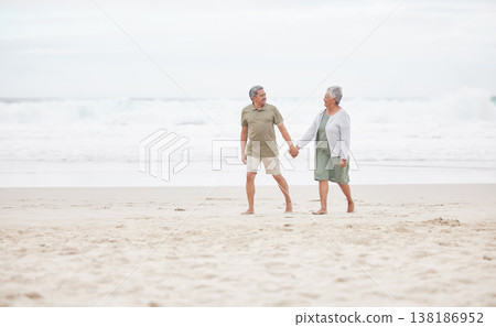 Senior, couple and hand holding on the beach for retirement vacation, holiday or adventure in summer. Elderly, man and woman for walking by ocean or sea with journey and happiness for relax and love Senior, couple and hand holding on the beach for retirement vacation, holiday or adventure in summer. Elderly, man and woman for walking by ocean or sea with journey and happiness for relax and love 138186952
