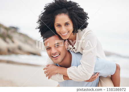 Portrait, piggyback and happy couple at the beach with love, bond and fun in nature together. Freedom, travel and face of excited people at sea with carrying, games or freedom celebration in Bali 138186972