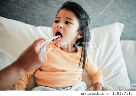 Girl child, check throat and sick in bed with virus, health and wellness, parent monitor daughter at home. Inflammation, illness and young kid with the flu or cold, medical help and support in bed Girl child, check throat and sick in bed with virus, health and wellness, parent monitor daughter at home. Inflammation, illness and young kid with the flu or cold, medical help and support in bed 138187112